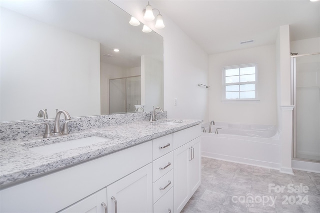 bathroom featuring tile patterned floors, double vanity, and independent shower and bath