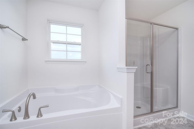 bathroom featuring tile patterned floors and separate shower and tub