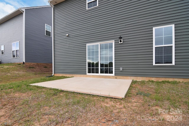 rear view of property featuring a patio