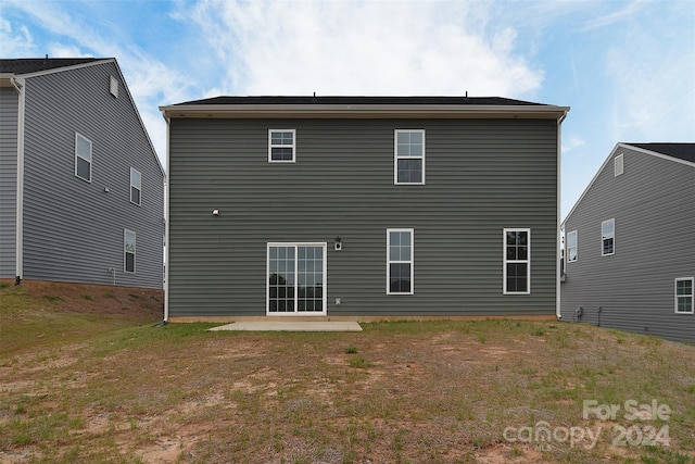 rear view of house featuring a patio and a yard