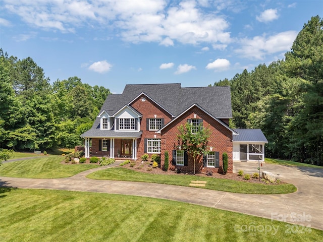 view of front facade featuring covered porch and a front yard