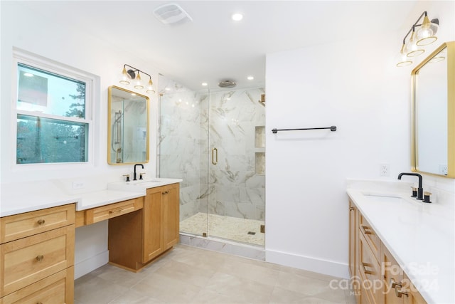 bathroom with vanity and a shower with shower door