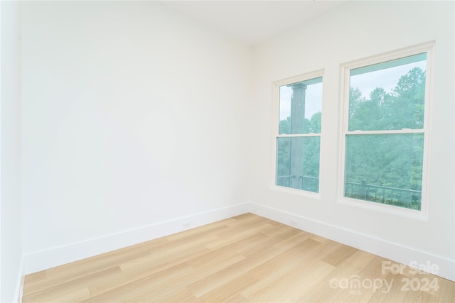 empty room featuring hardwood / wood-style flooring and a healthy amount of sunlight