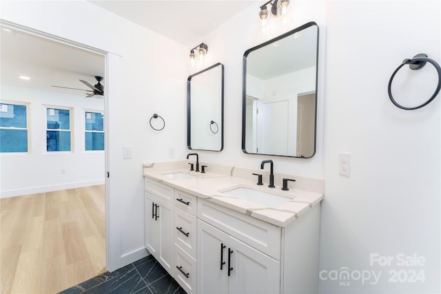 bathroom with ceiling fan and vanity