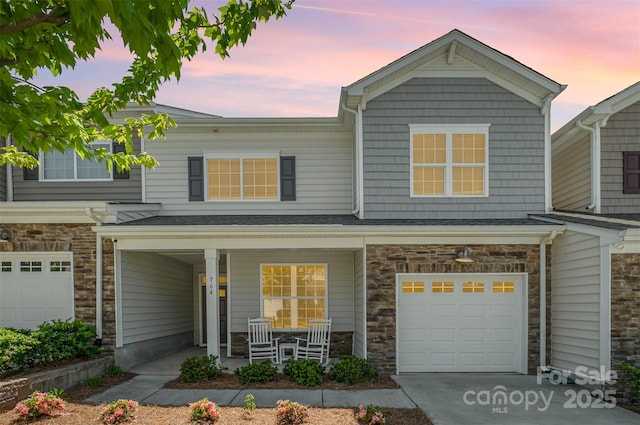 multi unit property featuring a garage and covered porch