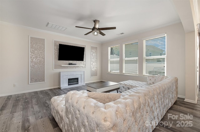 living room with crown molding, dark wood-type flooring, and ceiling fan