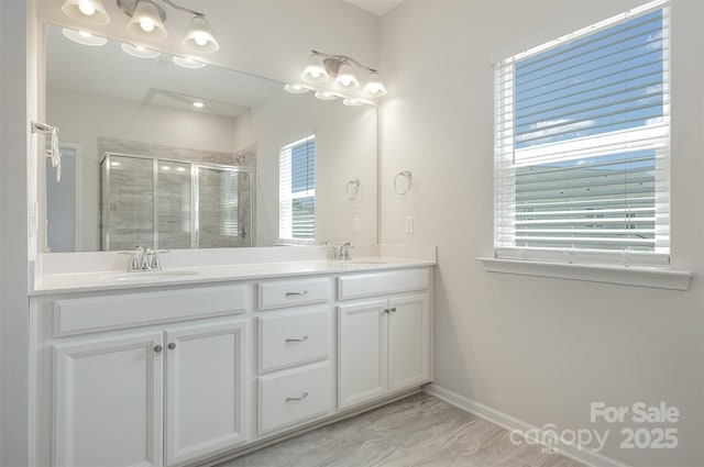 bathroom with vanity and a shower with shower door