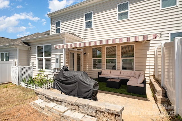 rear view of property featuring an outdoor hangout area and a patio area