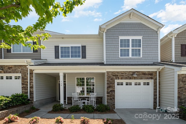 view of property with a garage and covered porch