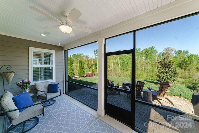 sunroom / solarium featuring ceiling fan