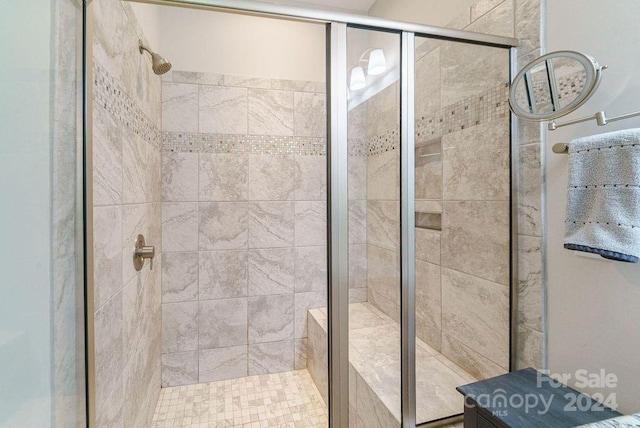 bathroom with a shower with door