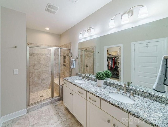 bathroom featuring vanity and a shower with door