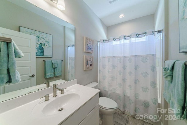 full bathroom featuring toilet, shower / bath combination with curtain, and vanity