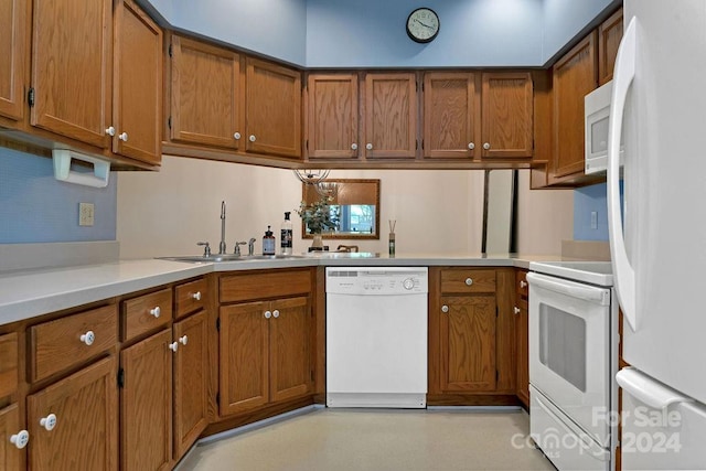 kitchen featuring white appliances and sink