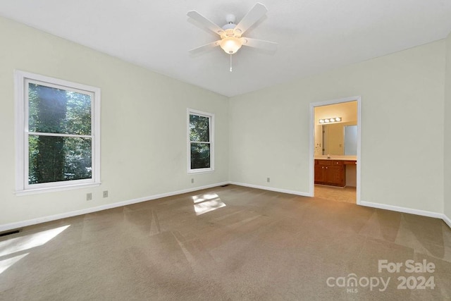 unfurnished room with ceiling fan and carpet floors