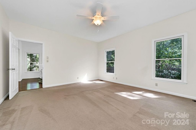 carpeted empty room with ceiling fan