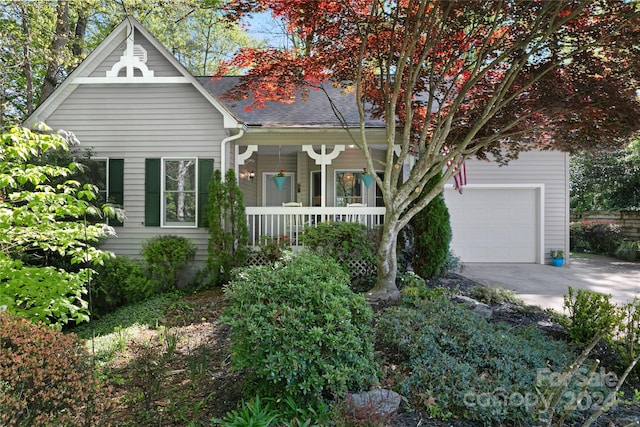 view of front of house featuring a porch and a garage