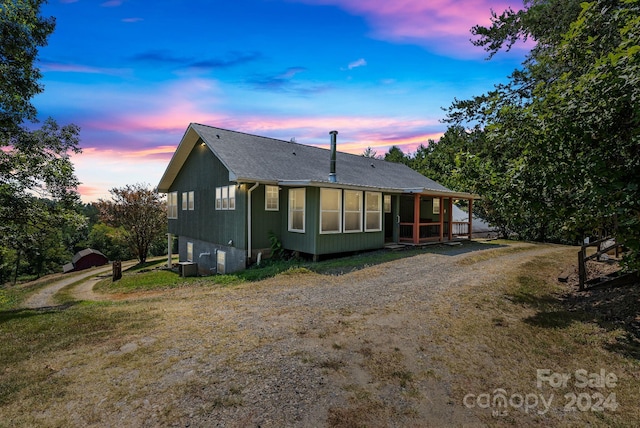 view of back house at dusk