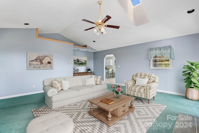 living room with vaulted ceiling, ceiling fan, and carpet