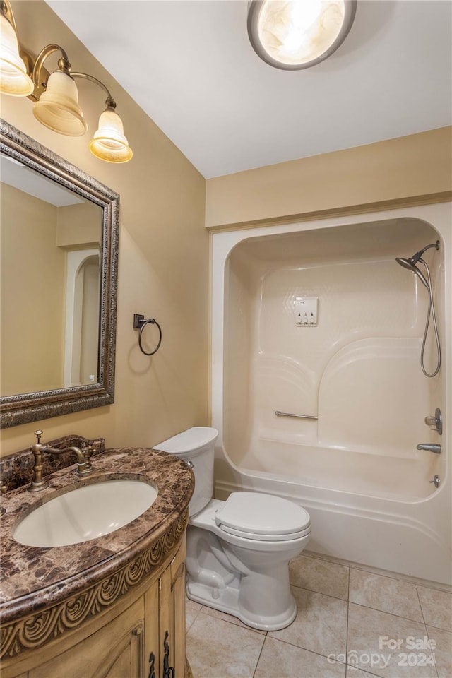 full bathroom featuring tub / shower combination, toilet, tile floors, and vanity