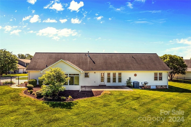 rear view of property featuring central AC, a yard, and a patio area