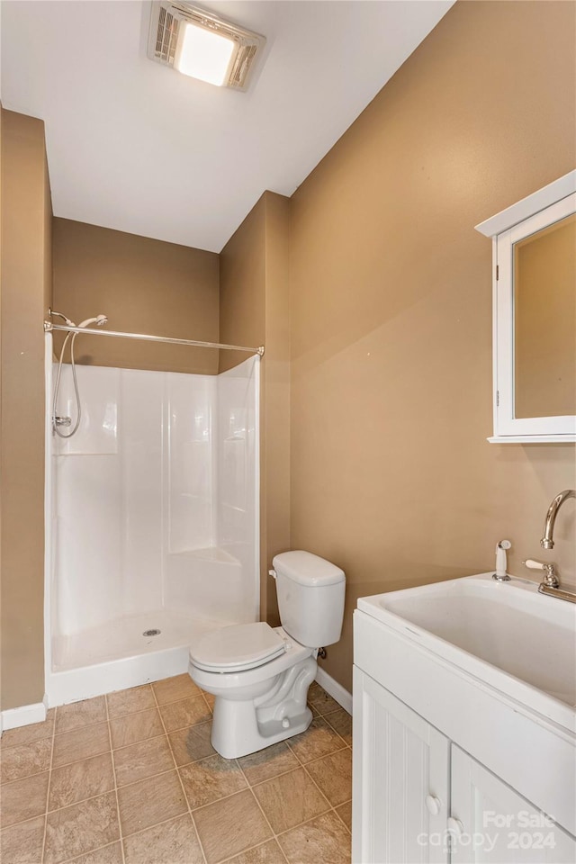 bathroom with walk in shower, vanity, toilet, and tile floors