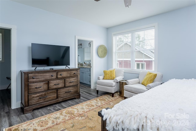 bedroom featuring ceiling fan, ensuite bathroom, and dark wood-type flooring