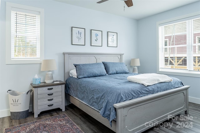 bedroom featuring multiple windows, ceiling fan, and dark wood-type flooring