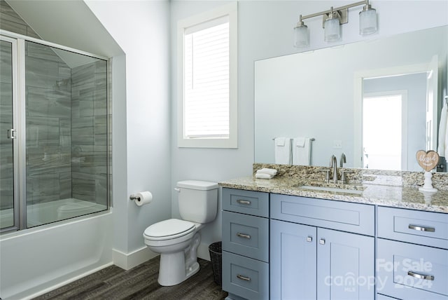 full bathroom featuring hardwood / wood-style floors, plenty of natural light, toilet, and large vanity