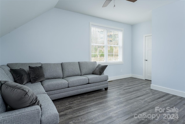 living room featuring vaulted ceiling, ceiling fan, and dark wood-type flooring