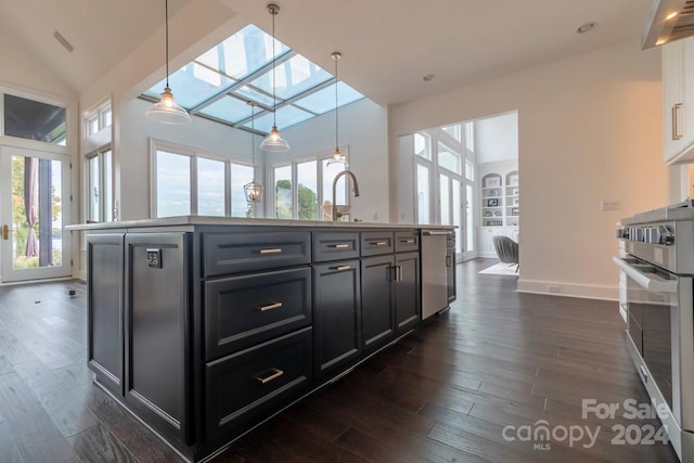 kitchen with a center island with sink, range, a skylight, and dark wood-type flooring