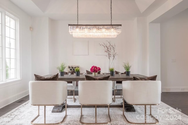 dining room featuring a notable chandelier, hardwood / wood-style flooring, and lofted ceiling