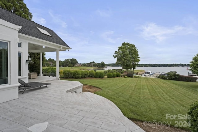 view of yard featuring a water view and a patio area