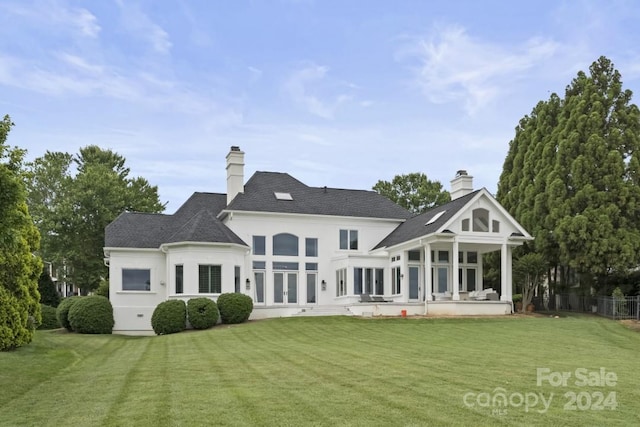 rear view of property with a lawn