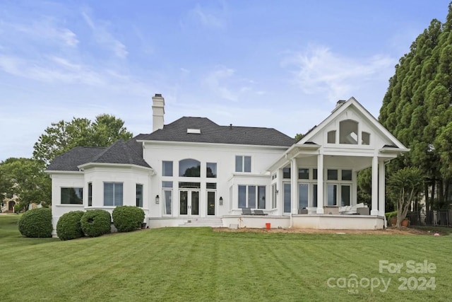 rear view of house with a yard