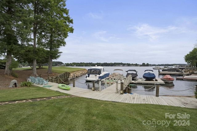 dock area featuring a water view and a lawn