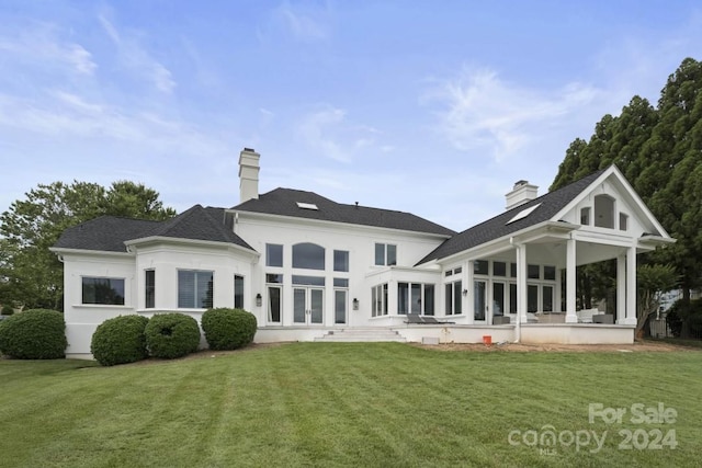 rear view of house featuring a yard and a patio area