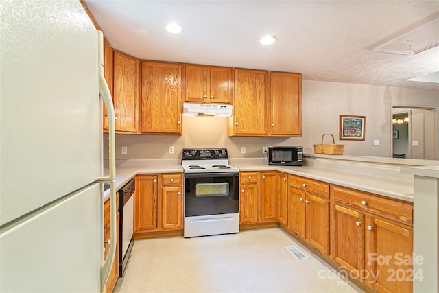 kitchen with a textured ceiling, white appliances, kitchen peninsula, and beverage cooler