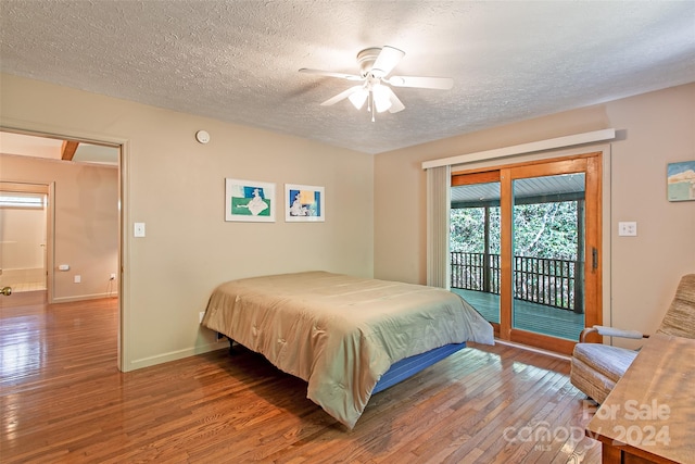 bedroom featuring access to outside, wood-type flooring, ceiling fan, and a textured ceiling