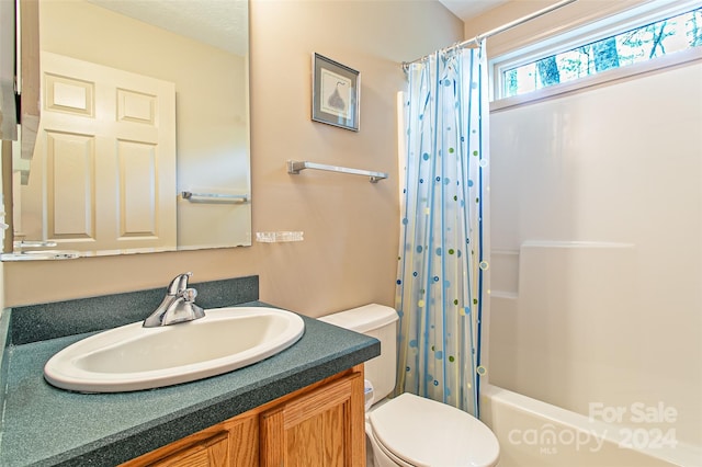 full bathroom with vanity, toilet, and shower / bath combo with shower curtain