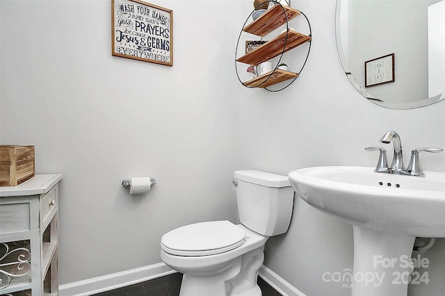 bathroom with tile flooring and toilet