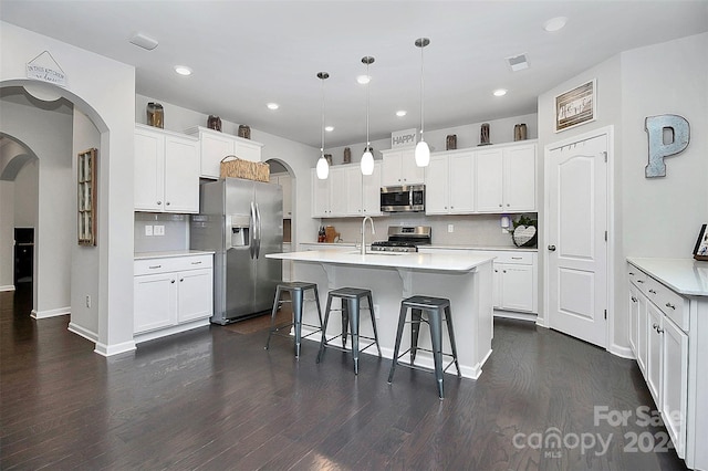 kitchen with tasteful backsplash, stainless steel appliances, and dark wood-type flooring