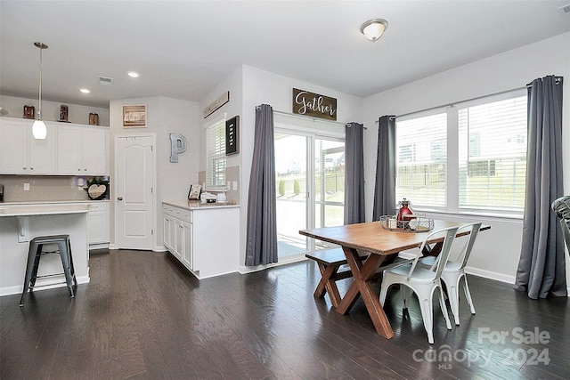 dining space with plenty of natural light and dark wood-type flooring