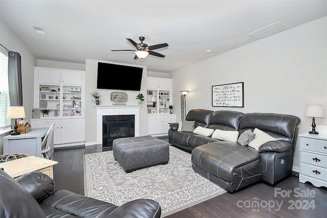 living room with ceiling fan, dark wood-type flooring, and built in features