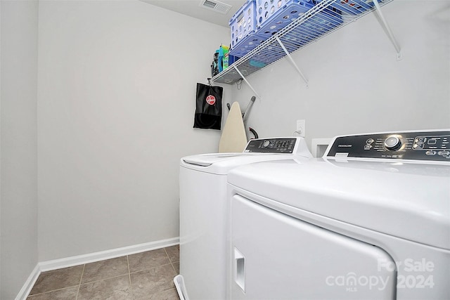 laundry room with tile floors and washing machine and dryer