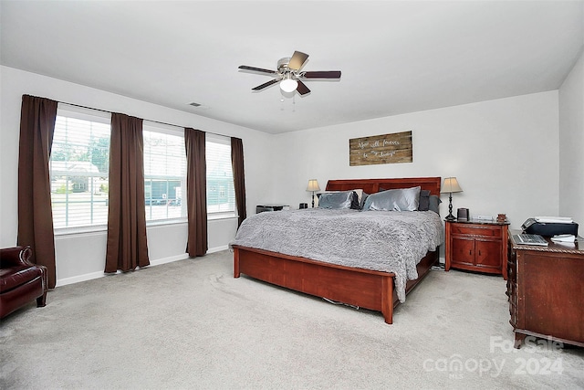 bedroom with ceiling fan and light carpet