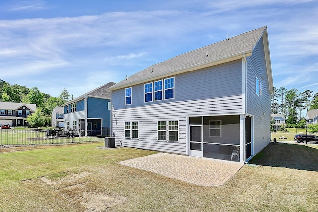 back of property with a patio, a lawn, central air condition unit, and a sunroom