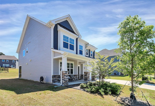 view of front of property with a front yard and covered porch