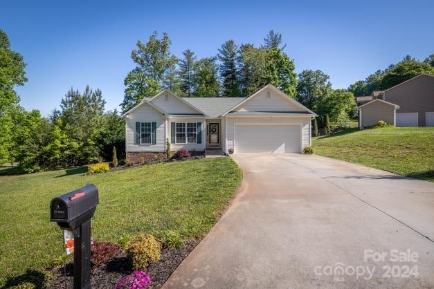 single story home featuring a garage and a front yard