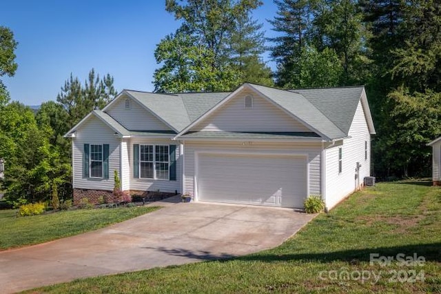 ranch-style home featuring a garage and a front lawn